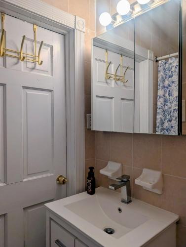 a bathroom with a white sink and a mirror at MANHATTAN ROSE Homestay in New York