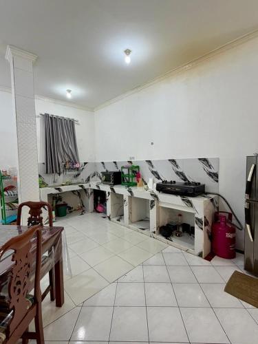 an empty room with desks in a room at Villa puncak 3 room in Cikundul