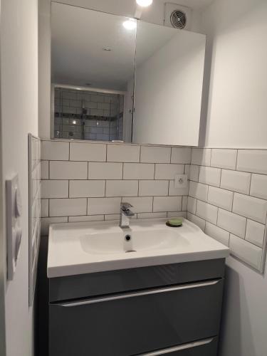 a bathroom with a sink and a mirror at Le Rocher au Thym in Limoux