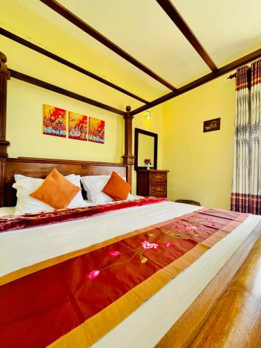 a bedroom with a large bed with flowers on it at Zentara Hills in Haputale