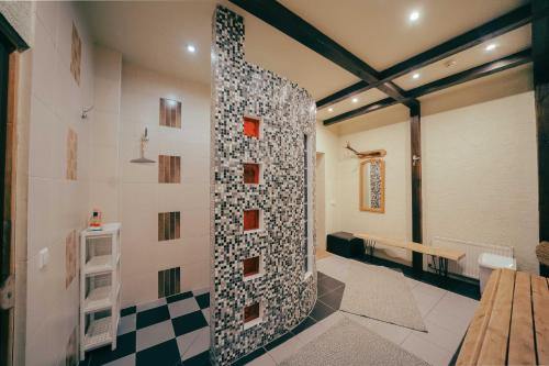 a room with a wall with a tile wall at Beachside Guest House Piejuras nams in Ķesterciems