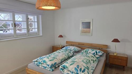 a bedroom with two beds and a window at The Garden Residence in Falkenburg