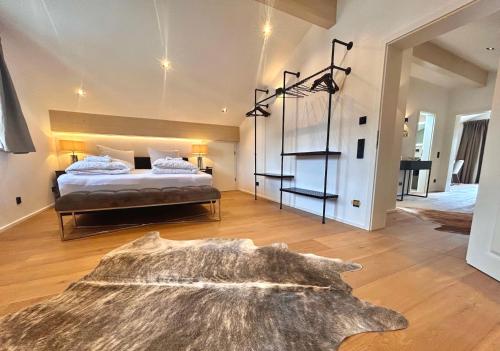 a bedroom with a large bed and a large rug at Ferienwohnung "Krainsbergkogel" - Edles Dachgeschossapartment mit Bergblick in Schliersee