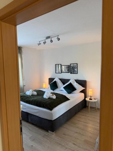 a bedroom with a large bed with two pillows at Apart63-Modern-3Room I Smart TV I Free Parking I Free WiFi in Hamm