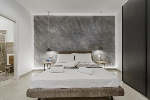 a bedroom with a large bed with two tables at Holiday burrone in Favignana