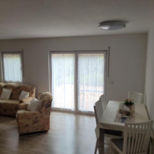a living room with a couch and a table and chairs at Ferienwohnung Weber in Mühlau