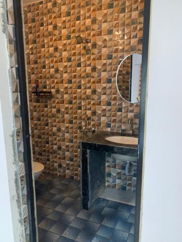 a bathroom with a sink and a mirror at Aasra Studios in Agonda