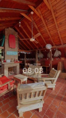 a room with tables and chairs and a ceiling at Las Grullas in Villa Gesell