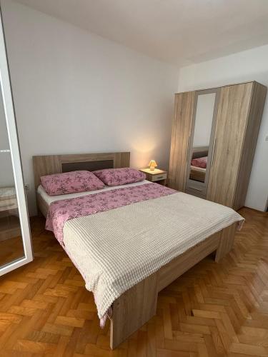 a bedroom with a large bed and a mirror at Coastal dream in Razvala