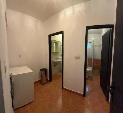 a bathroom with a toilet and a sink and a mirror at Coastal dream in Razvala