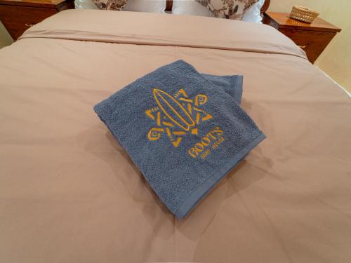a pillow on top of a bed at Roots Surf House - Anza in Agadir