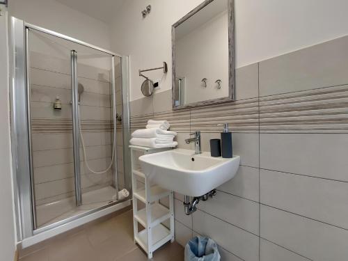 a bathroom with a sink and a shower at My Way Rooms - Affittacamere in centro Trieste in Trieste
