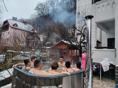 a group of people in a hot tub at Vila Brazilor in Căciulata