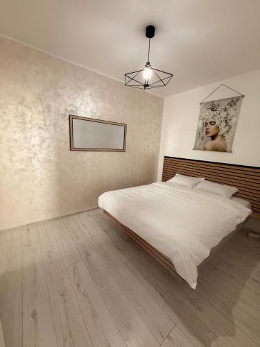 a bedroom with a large white bed in it at Cleo Residence 1 Ghiroda in Ghiroda