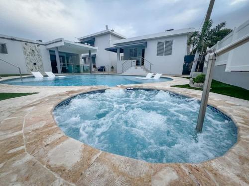 a hot tub in the backyard of a house at Isabela Luxury Escape sky view in Isabela
