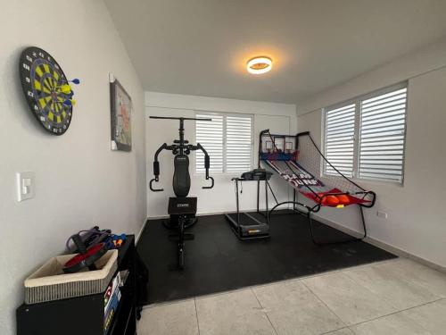 a room with a gym with a treadmill and a simulator at Isabela Luxury Escape sky view in Isabela