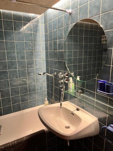 a bathroom with a sink and a mirror and a tub at Kulmhof in Tauplitz