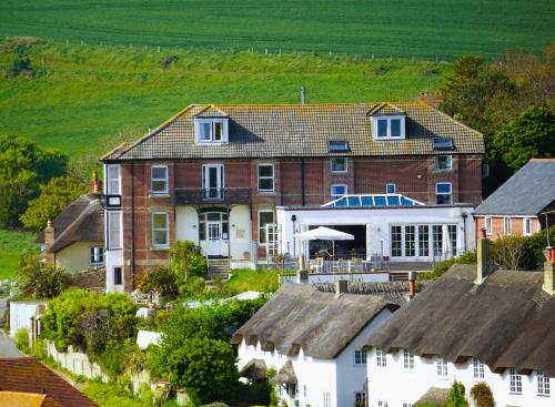 an aerial view of a house in a village at Durdle Door Hotel in Lulworth Cove