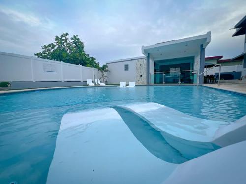 a swimming pool with blue water in front of a building at Isabela Luxury Escape Serenity in Isabela