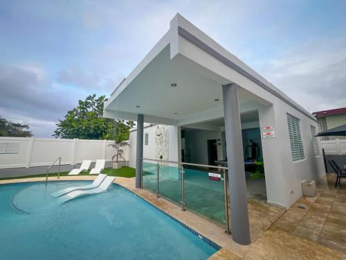 a swimming pool in the backyard of a house at Isabela Luxury Escape Serenity in Isabela