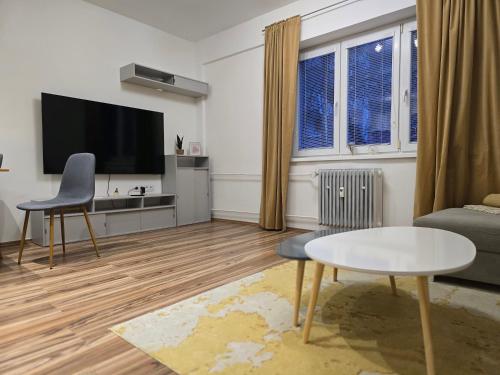 a living room with a couch and a tv at Central City Stay Šancová in Staré Mesto