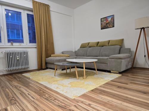 a living room with a couch and a table at Central City Stay Šancová in Staré Mesto