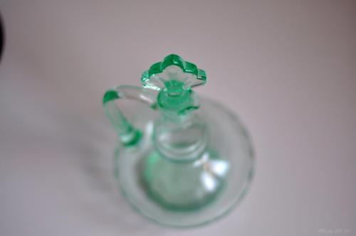 a green glass vase sitting on a table at Pensionat Prästgården in Töreboda