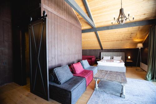 a room with a couch and a bed and a table at Hotel Roshe Gudauri in Gudauri