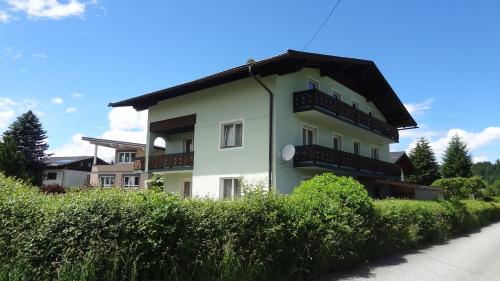 a building with balconies on the side of a street at Appartements Gassner in Bruck an der Großglocknerstraße