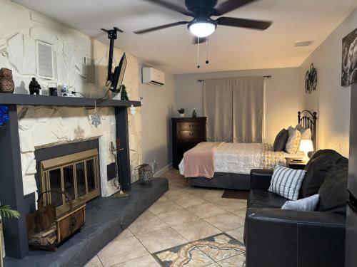 a living room with a bed and a fireplace at PRIVATE STUDIO near Busch Gardens & USF in Tampa