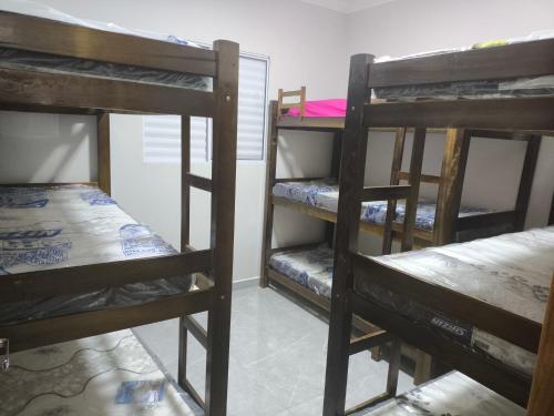 a group of bunk beds in a room at ótima casa em Itanhaém in Itanhaém