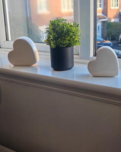 two hearts and a plant on a window sill at Park View House - Spacious 3 Bed Home in Burton in Burton upon Trent