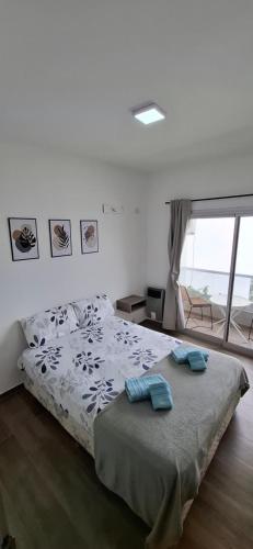 a bedroom with a bed with two pillows on it at ADS DEPARTAMENToS 2 in La Plata