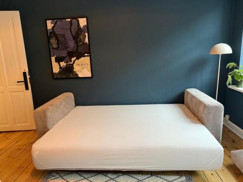 a bed in a room with a white mattress at Greenbrook - Blue Lounge in Aalborg