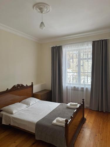 a bedroom with a bed with two towels on it at RedRose guest house Dilijan in Dilijan