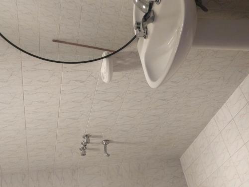 a bathroom with a urinal on a tiled floor at La casa de Los Patitos in Arroyo de Los Patos