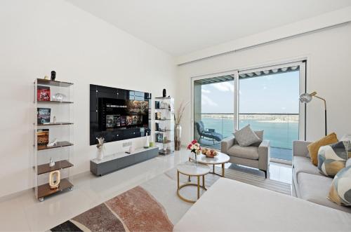 a living room with a view of the ocean at Luxury 2BR Emaar Beachfront with Private Beach & Infinity Pool, Palm Jumeirah & Atlantis Views in Dubai