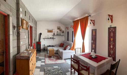 a living room with a table and a couch at Colonia Natura Apartmanpark in Sitke