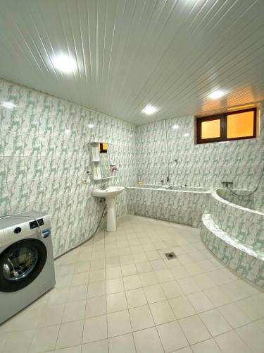 a bathroom with a washing machine and a sink at RedRose guest house Dilijan in Dilijan