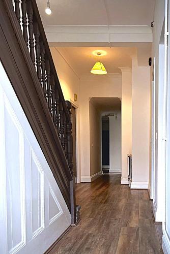an empty hallway with a staircase in a house at Atherley House - Winter Sale! Spacious Self Catered Rooms in Southampton