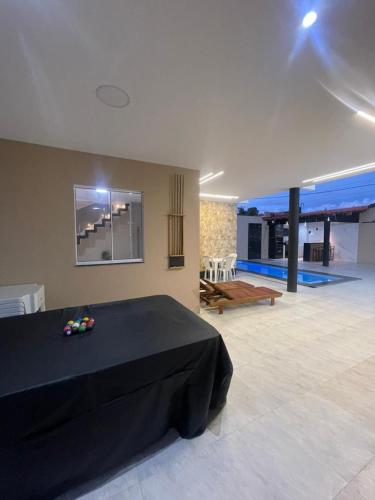 a bedroom with a black bed in a room at Casa veraneio2 in Camacari