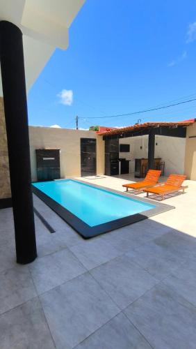 a swimming pool on the roof of a house at Casa veraneio2 in Camacari