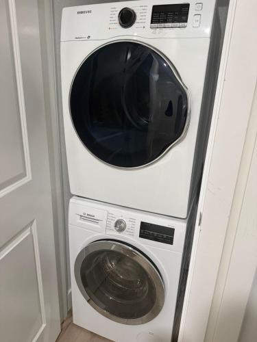 a white washer and dryer in a room at Executive 2 Bedroom Apartment with Free Parking in Prince George