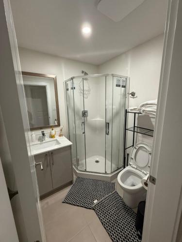 a bathroom with a shower and a toilet and a sink at 2 Bedrooms Private EntRance wifi Free Parking in Prince George