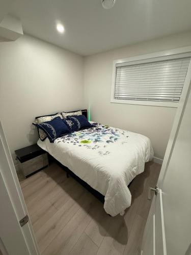 a bedroom with a bed and a window at 2 Bedrooms Private EntRance wifi Free Parking in Prince George
