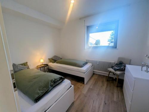 a small bedroom with a bed and a window at Wohnen am Wald mit Pool & Sauna in Unterkirnach