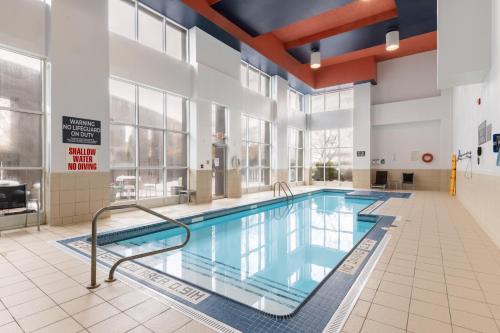 a swimming pool in a large building with a large window at Holiday Inn Hotel & Suites London by IHG in London