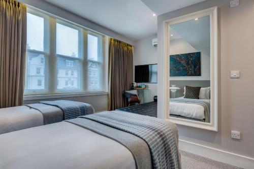 Ένα ή περισσότερα κρεβάτια σε δωμάτιο στο Hotel 55