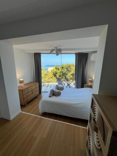 a bedroom with a bed with a view of the ocean at Villa Solanella in Coti-Chiavari