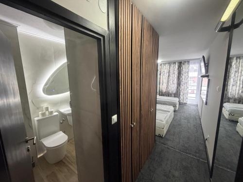 a bathroom with a toilet and a sink at Hotel Bosna in Kladanj